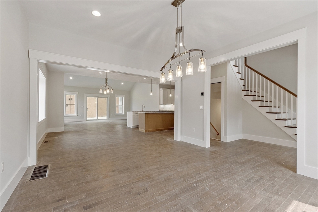 22 Waites Crossing Norfolk, MA 02056 - Photo 10 of 33 a view of a hallway with wooden floor and staircase