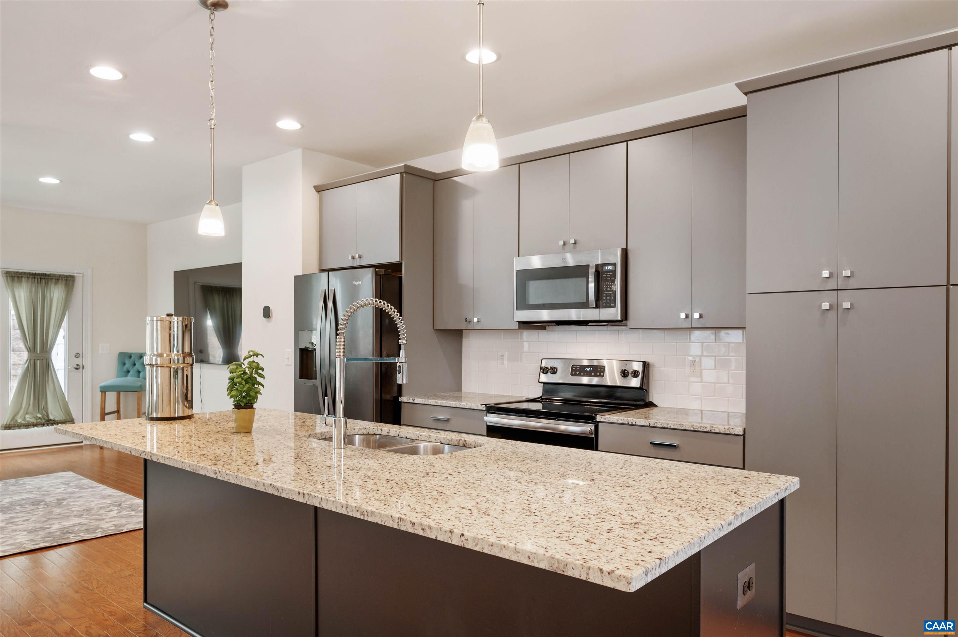 1670 Delphi Drive Charlottesville, VA 22911 - Photo 4 of 47 a kitchen with stainless steel appliances granite countertop a sink refrigerator and microwave