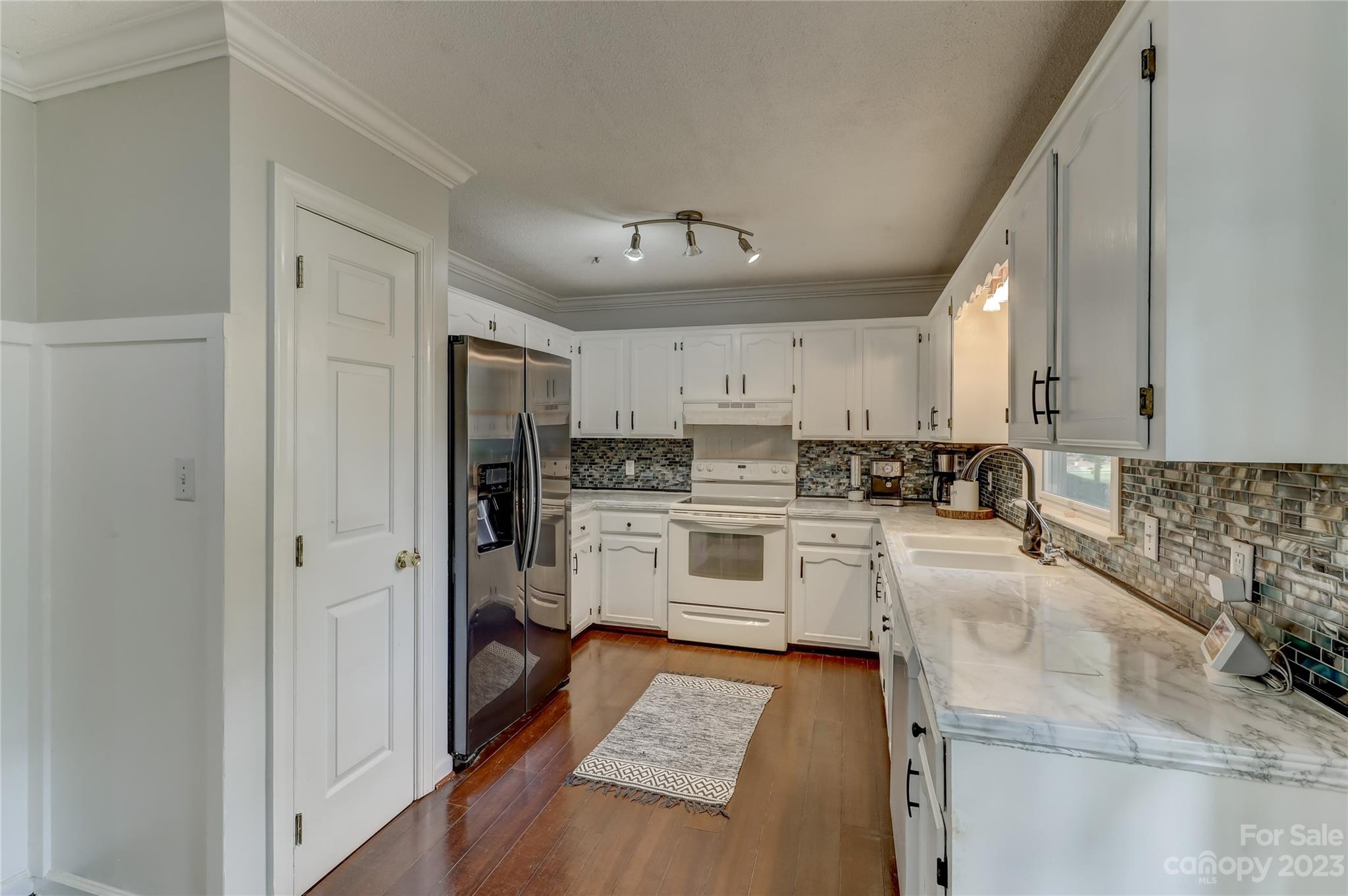 1631 Amanda Lane Rock Hill, SC 29730 - Photo 11 of 43 a kitchen with white cabinets and stainless steel appliances