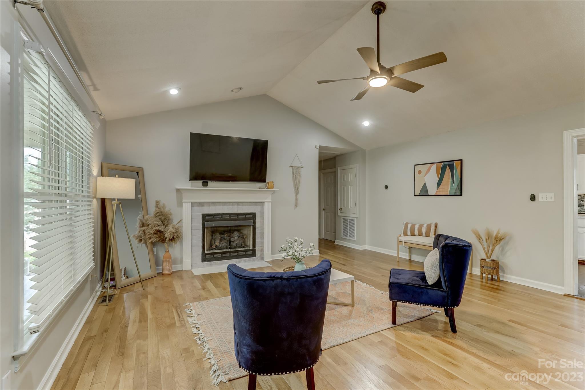 1631 Amanda Lane Rock Hill, SC 29730 - Photo 6 of 43 a living room with furniture a fireplace and a flat screen tv