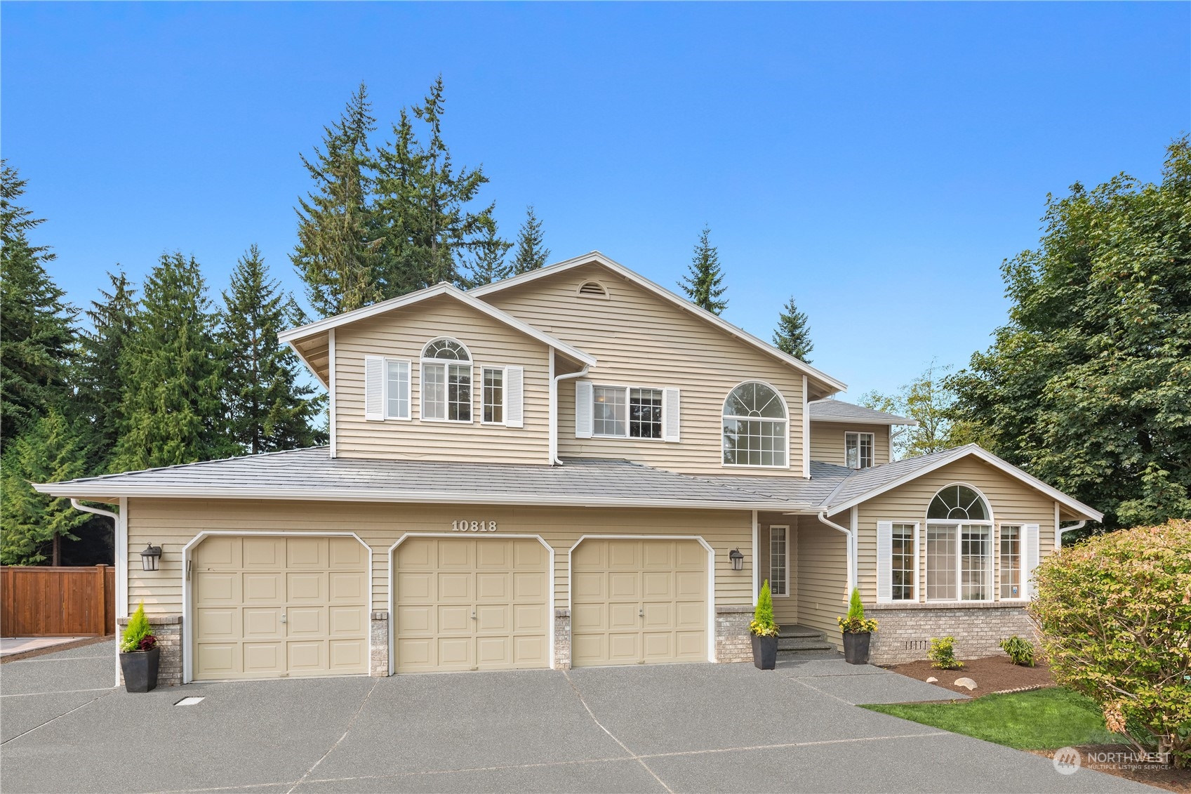 a front view of a house with a garden