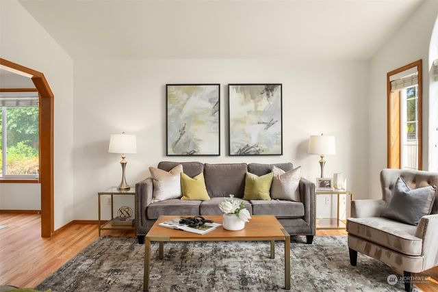 a living room with furniture a lamp and a table