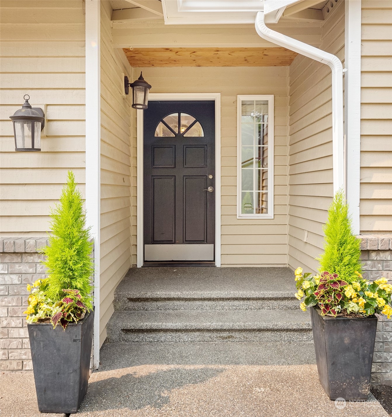 10818 27th Avenue Southeast Everett, WA 98208 - Photo 3 of 36 a front view of a house with potted plants