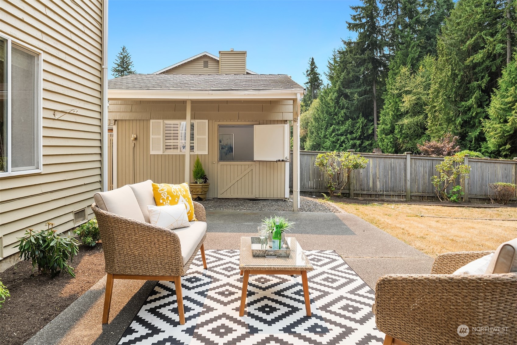10818 27th Avenue Southeast Everett, WA 98208 - Photo 32 of 36 a view of a patio with table and chairs with wooden fence and plants