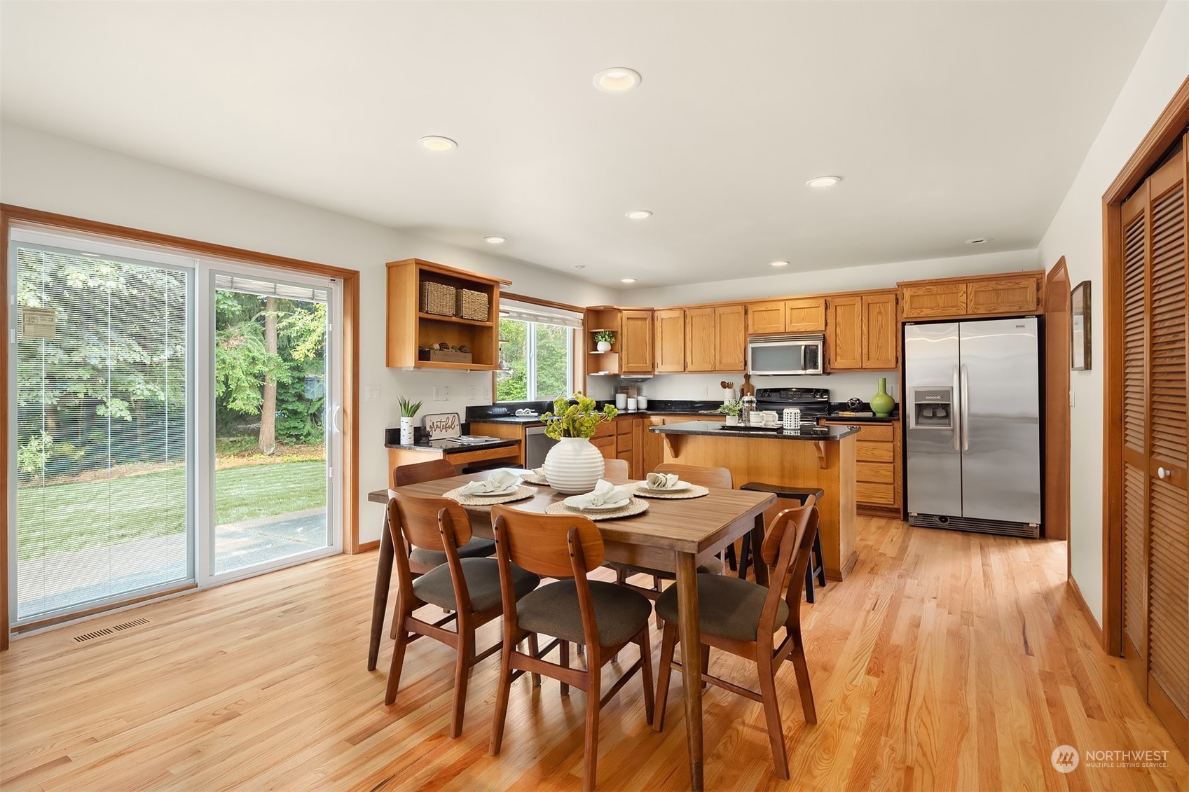 10818 27th Avenue Southeast Everett, WA 98208 - Photo 10 of 36 a dining room with stainless steel appliances granite countertop a dining table chairs refrigerator and sink