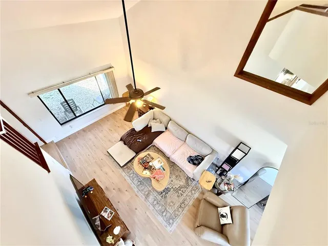 a view of living room with furniture and wooden floor
