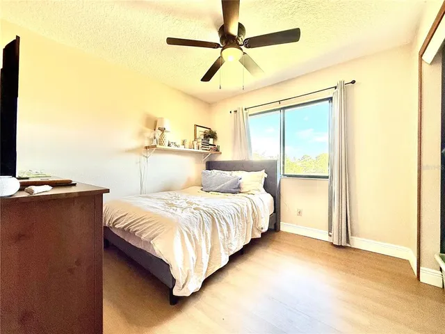 a bed room with a bed and a night stand