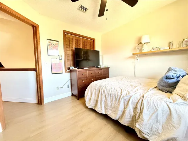 a bedroom with a bed and flat screen tv