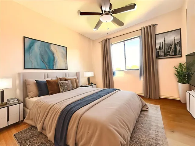 a bedroom with a large bed and a chandelier