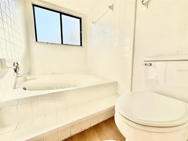 a bathroom with a bathtub and a toilet