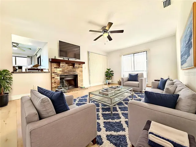 a living room with furniture a fireplace and a flat screen tv