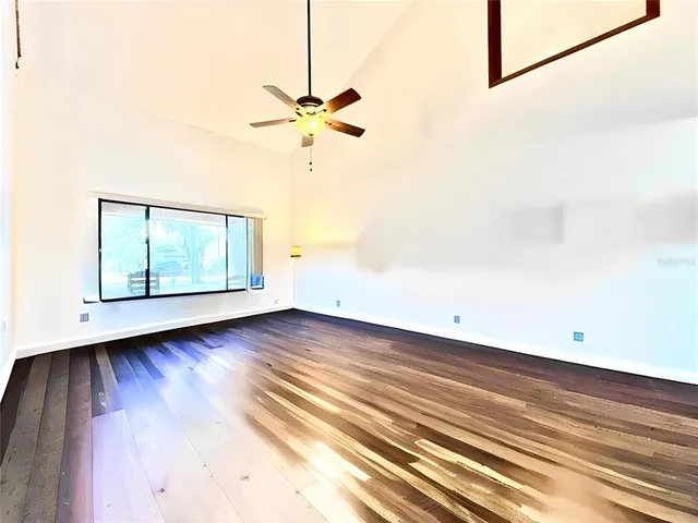 a view of a room with wooden floor and window