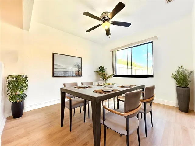 a view of a dining room with furniture and a potted plant
