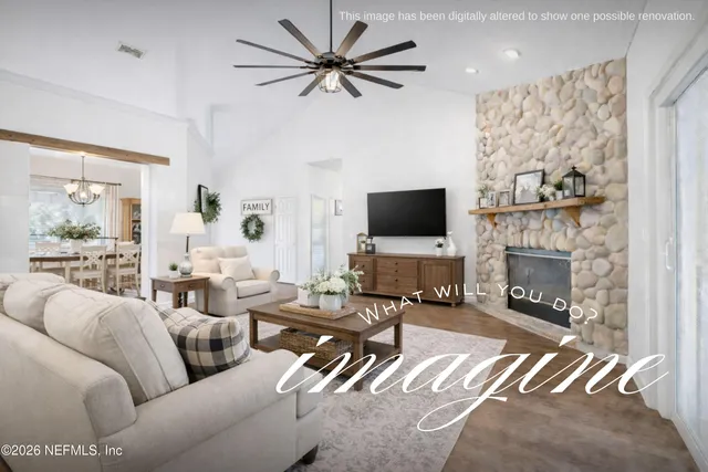 a kitchen with stainless steel appliances granite countertop a refrigerator a stove and a dining table with wooden floor