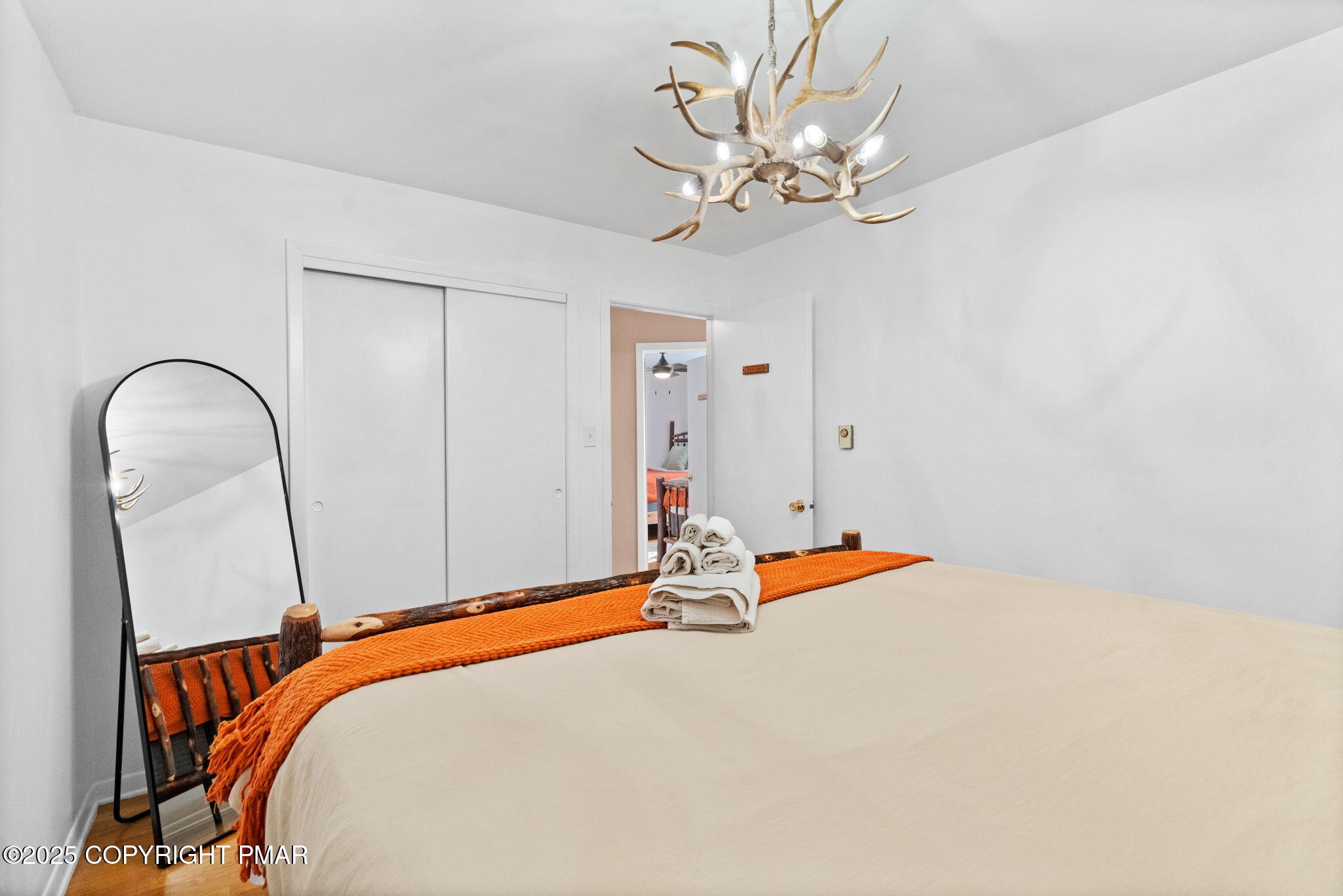 128 Winding Hill Road Pocono Pines, PA 18350 - Photo 26 of 77 a bed room with a bed and a chandelier