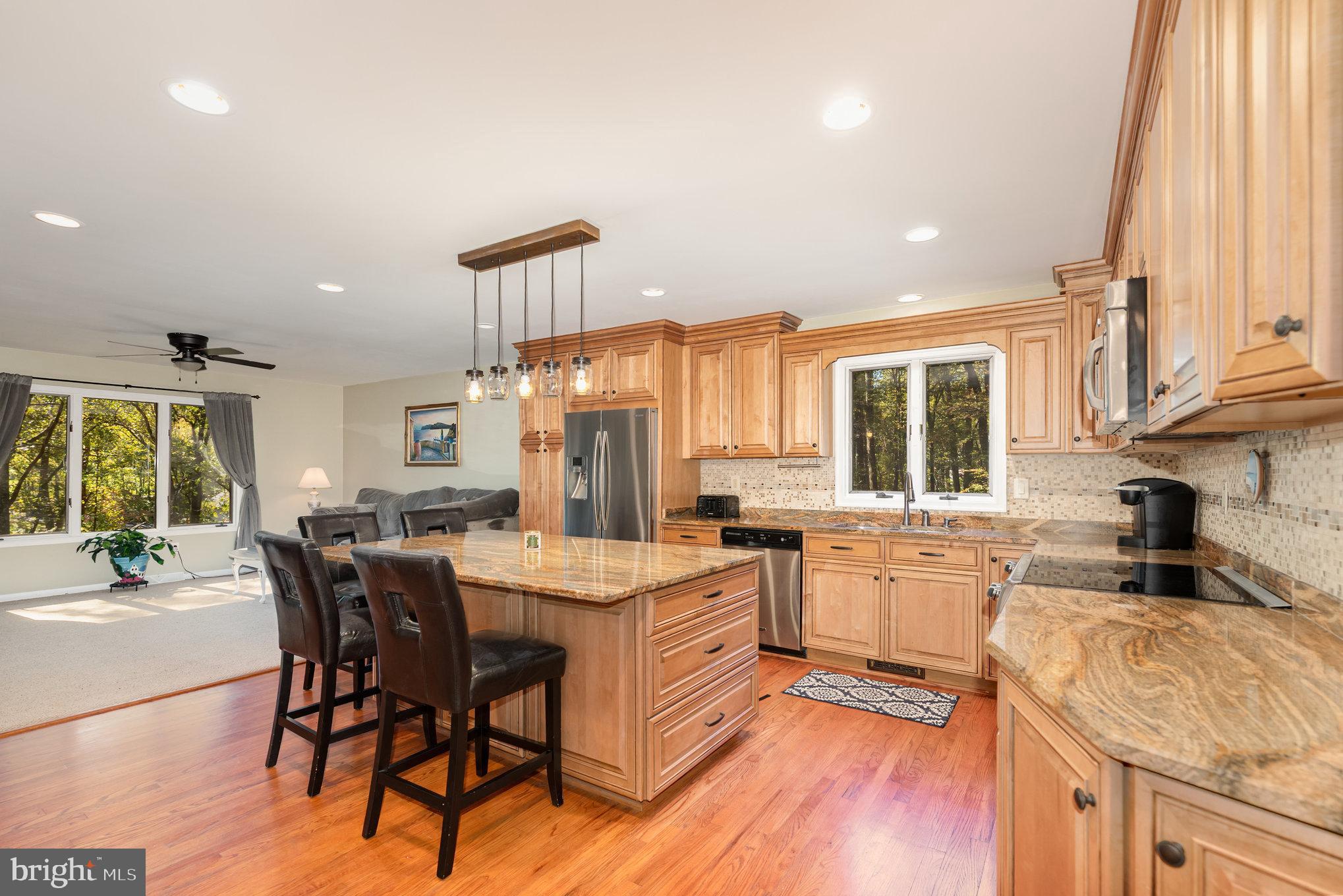 3827 Justin Road Monkton, MD 21111 - Photo 11 of 51 a kitchen with a stove a sink a dining table and chairs