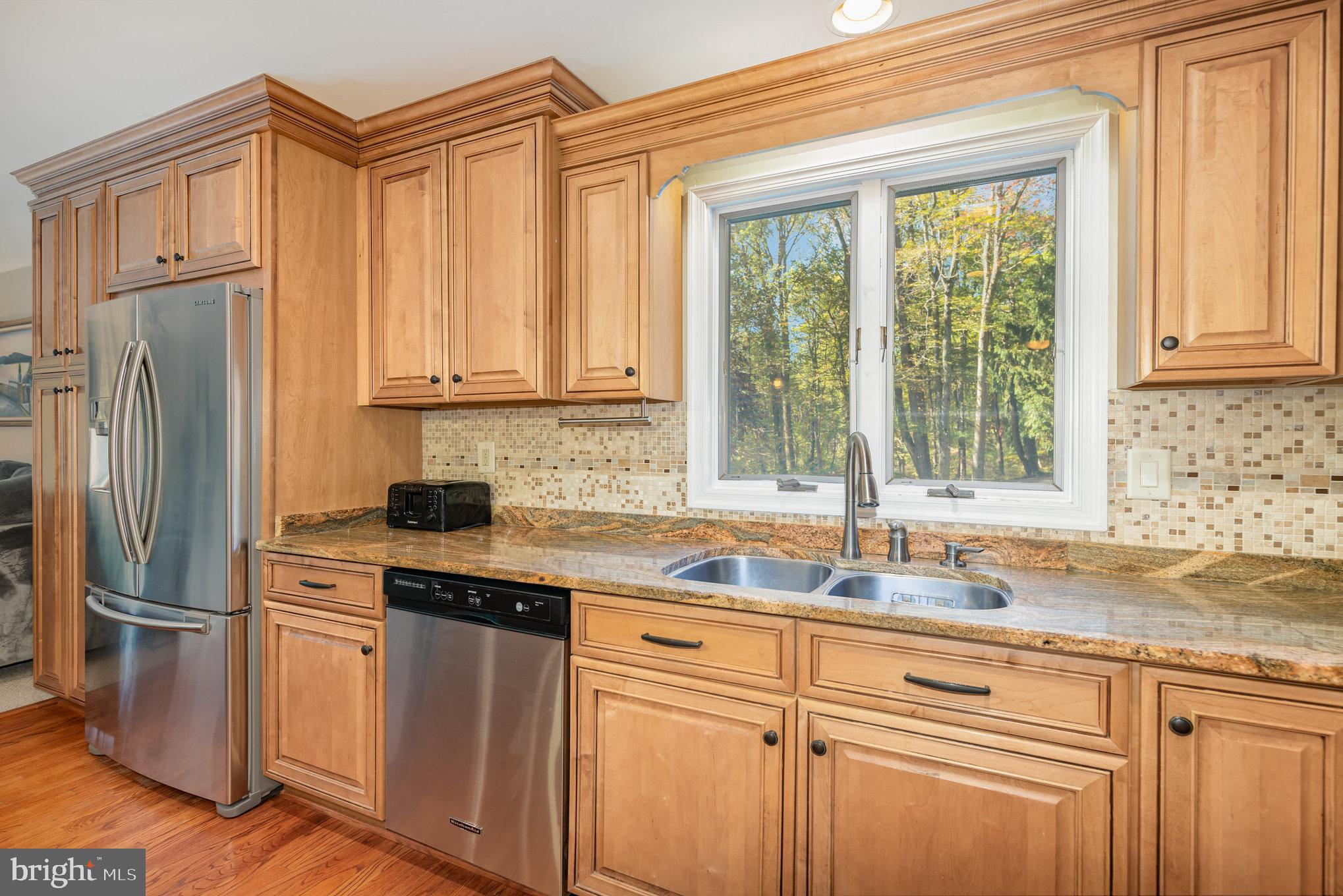 3827 Justin Road Monkton, MD 21111 - Photo 14 of 51 a kitchen with stainless steel appliances granite countertop a sink and a refrigerator
