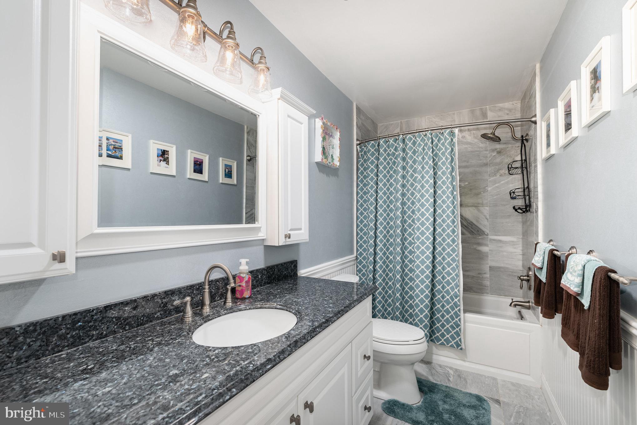 3827 Justin Road Monkton, MD 21111 - Photo 21 of 51 a bathroom with a granite countertop sink toilet and shower