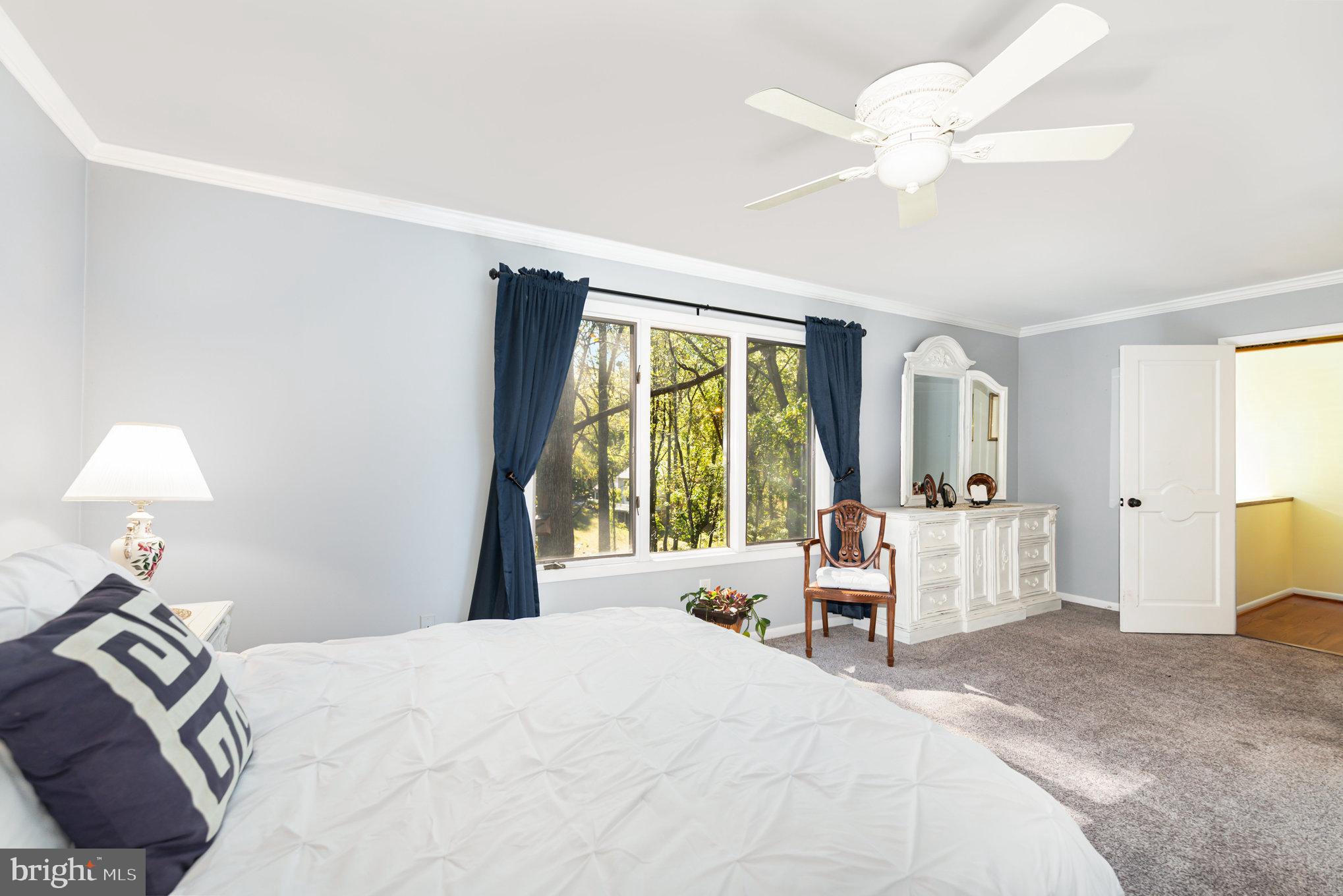 3827 Justin Road Monkton, MD 21111 - Photo 24 of 51 a bedroom with a large bed and a chandelier