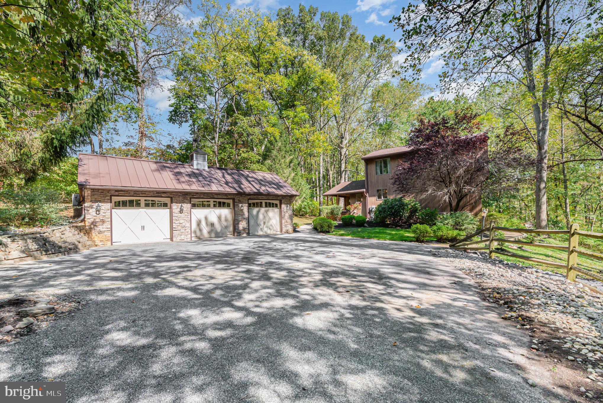 3827 Justin Road Monkton, MD 21111 - Photo 44 of 51 a front view of a house with a garden and tree