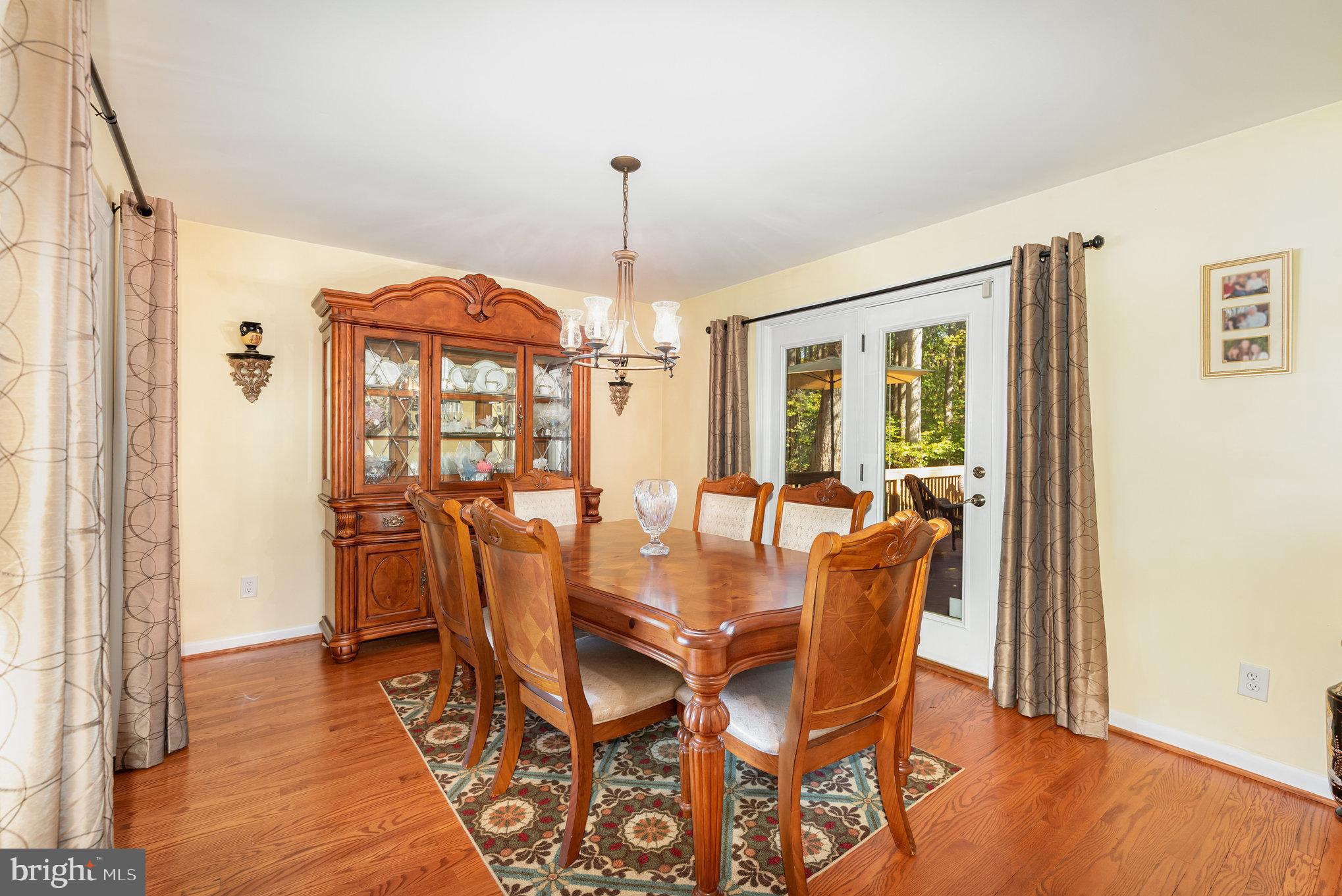 3827 Justin Road Monkton, MD 21111 - Photo 7 of 51 a dining room with furniture a chandelier and wooden floor