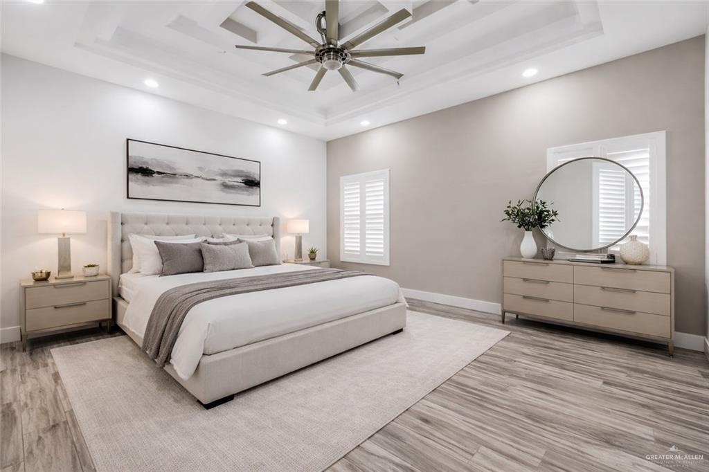 1315 Thompson Road Mission, TX 78573 - Photo 17 of 38 Bedroom with ceiling fan, light wood-type flooring, recessed lighting, and a raised ceiling