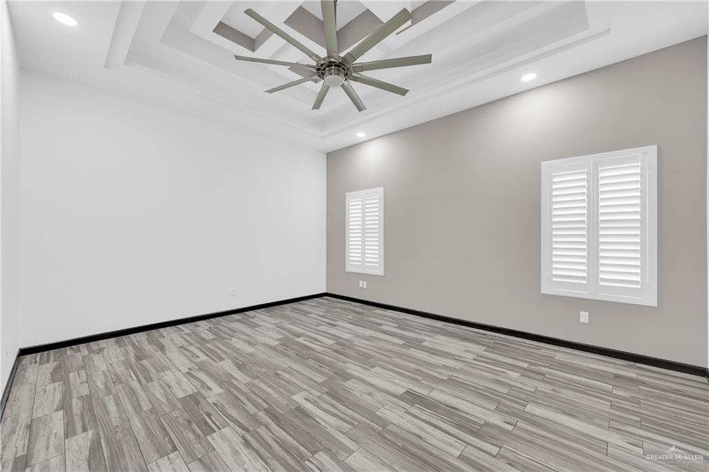 1315 Thompson Road Mission, TX 78573 - Photo 18 of 38 Unfurnished room with a raised ceiling, light wood-style floors, recessed lighting, and ceiling fan
