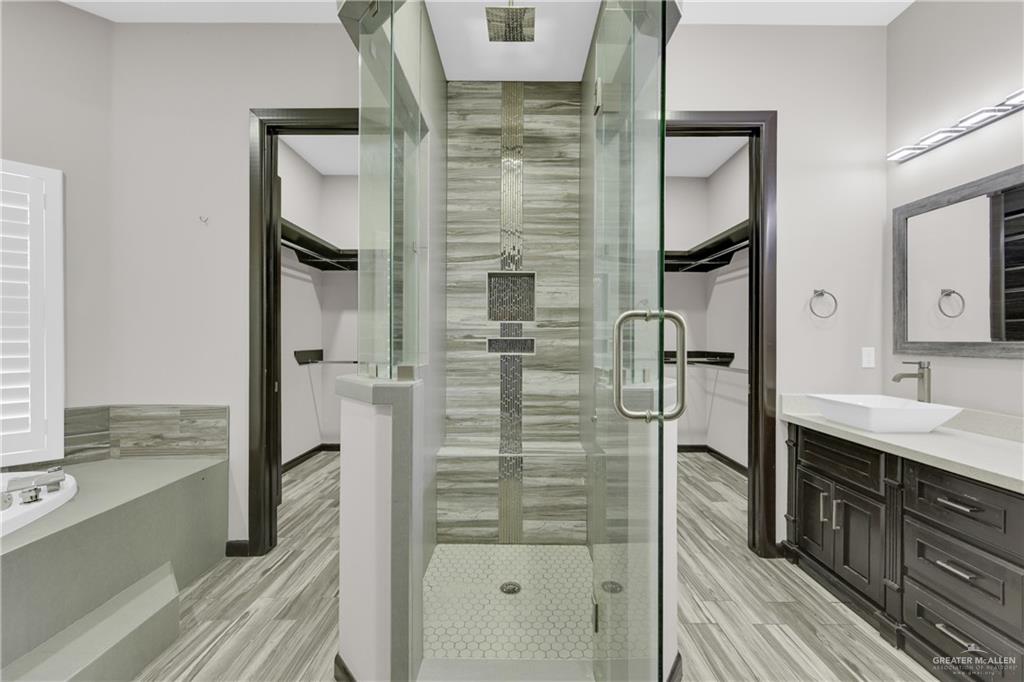 1315 Thompson Road Mission, TX 78573 - Photo 19 of 38 Full bathroom with a spacious closet, vanity, and a shower stall