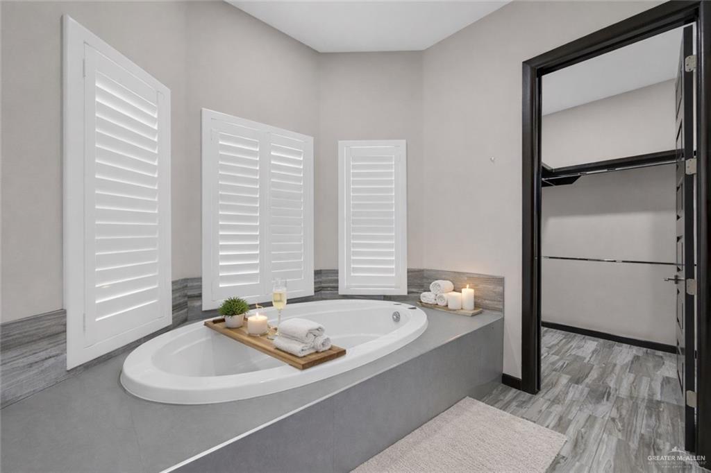 1315 Thompson Road Mission, TX 78573 - Photo 20 of 38 Bathroom with a bath and light wood finished floors