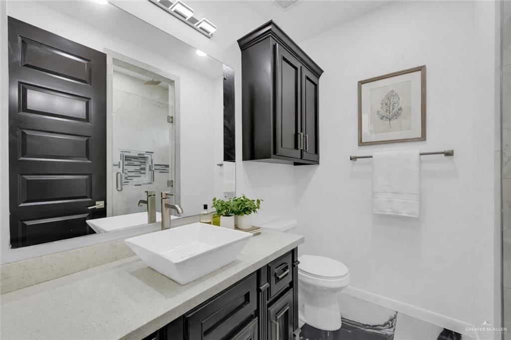 1315 Thompson Road Mission, TX 78573 - Photo 25 of 38 Full bathroom featuring a marble finish shower and vanity