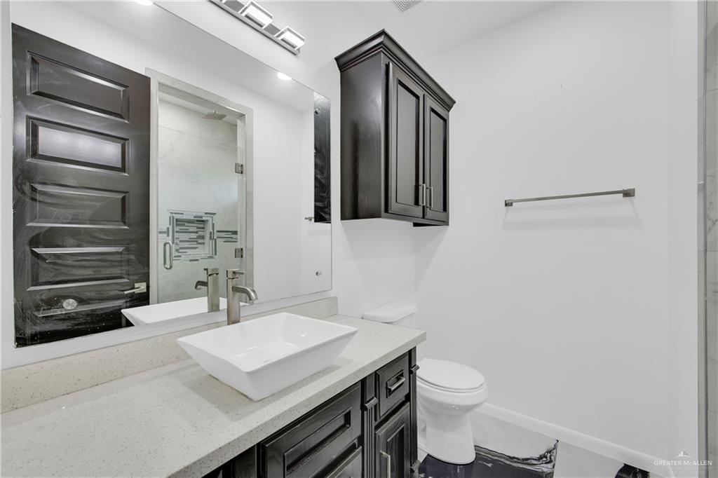 1315 Thompson Road Mission, TX 78573 - Photo 26 of 38 Full bath featuring vanity and a marble finish shower