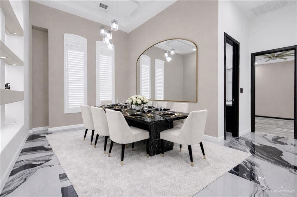 1315 Thompson Road Mission, TX 78573 - Photo 6 of 38 Dining area with light marble finish flooring and a chandelier