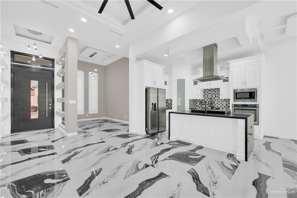 1315 Thompson Road Mission, TX 78573 - Photo 38 of 38 Kitchen featuring open floor plan, recessed lighting, a raised ceiling, stainless steel appliances, and island range hood