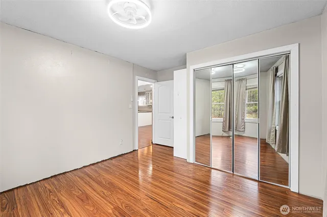 a view of an empty room with wooden floor