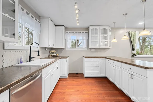 a kitchen with a sink stove and cabinets