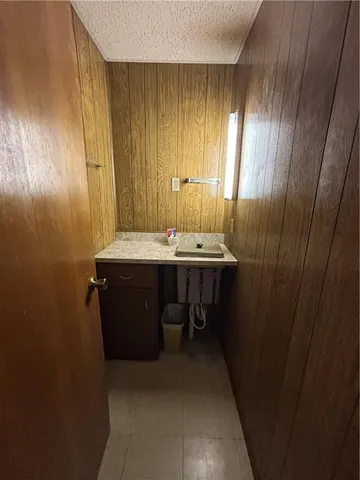 a view of an empty room with wooden walls