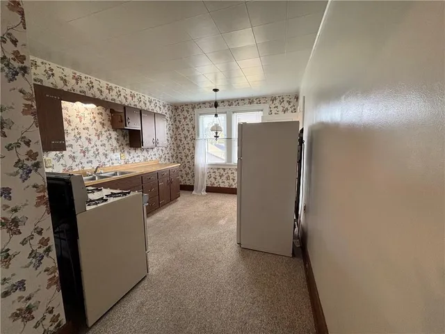 a kitchen with refrigerator and microwave