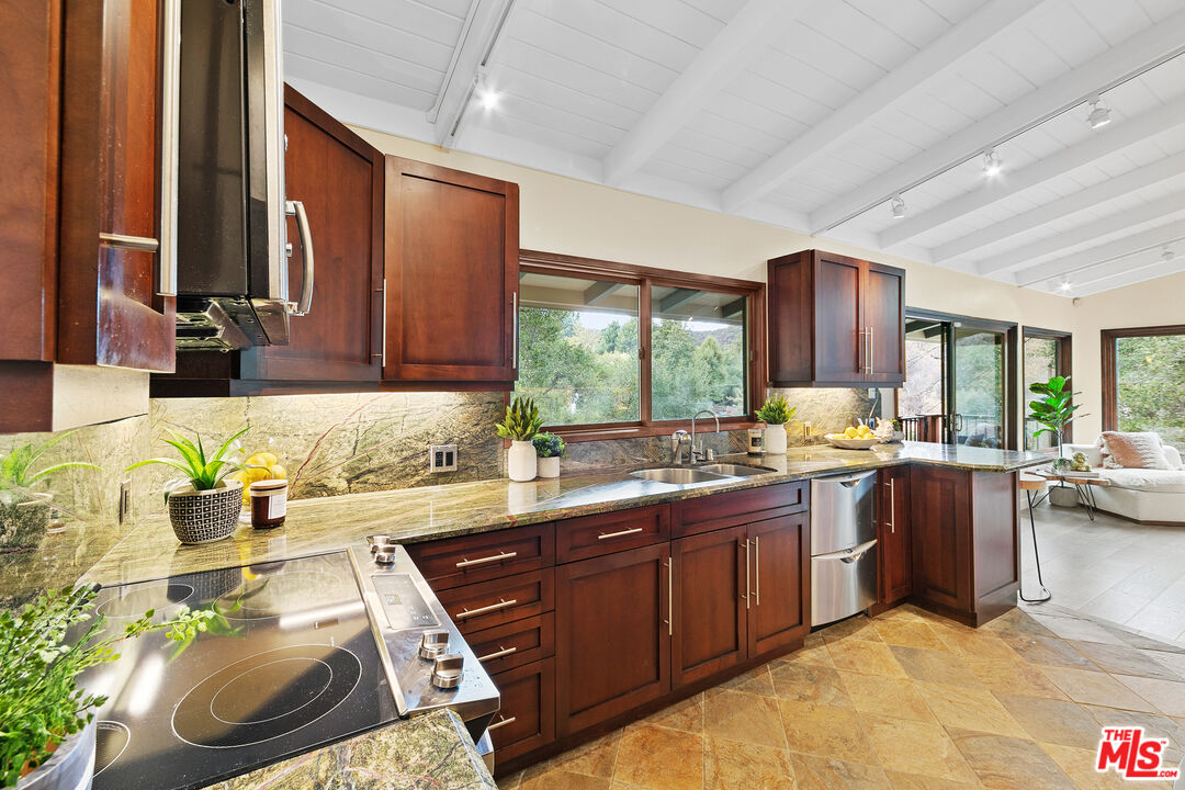 25659 Aline Way Calabasas, CA 91302 - Photo 15 of 53 a kitchen with a sink stove and cabinets