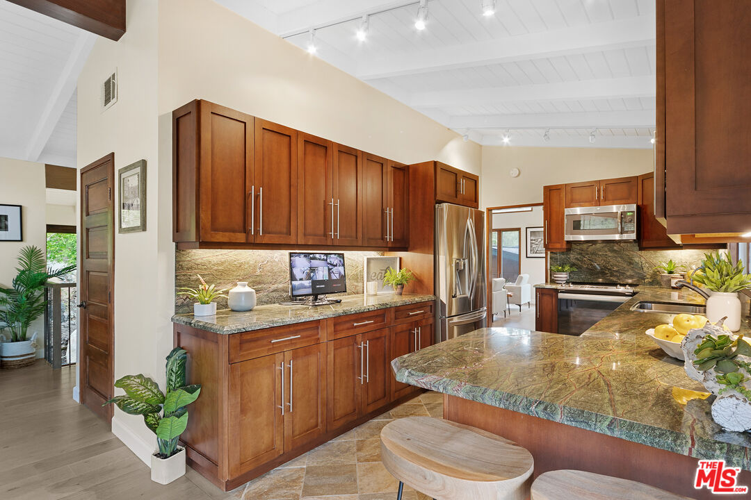 25659 Aline Way Calabasas, CA 91302 - Photo 16 of 53 a kitchen with sink cabinets and outdoor space