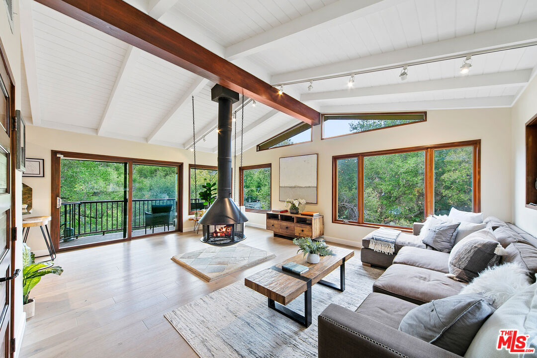25659 Aline Way Calabasas, CA 91302 - Photo 20 of 53 a living room with furniture and a floor to ceiling window