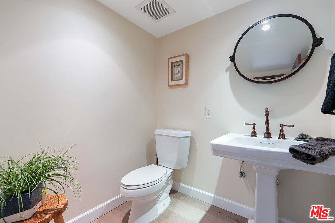 25659 Aline Way Calabasas, CA 91302 - Photo 22 of 53 a bathroom with a toilet a sink and mirror