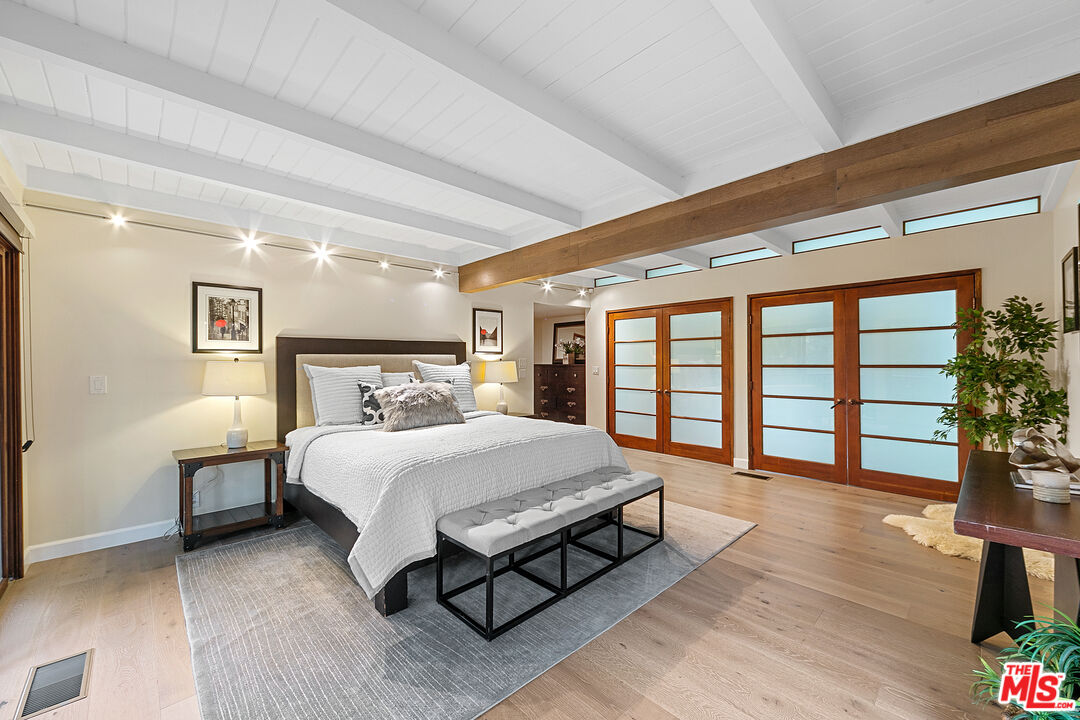 25659 Aline Way Calabasas, CA 91302 - Photo 26 of 53 a spacious bedroom with a bed and a large window