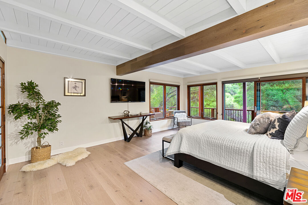 25659 Aline Way Calabasas, CA 91302 - Photo 27 of 53 a bedroom with a bed and a potted plant