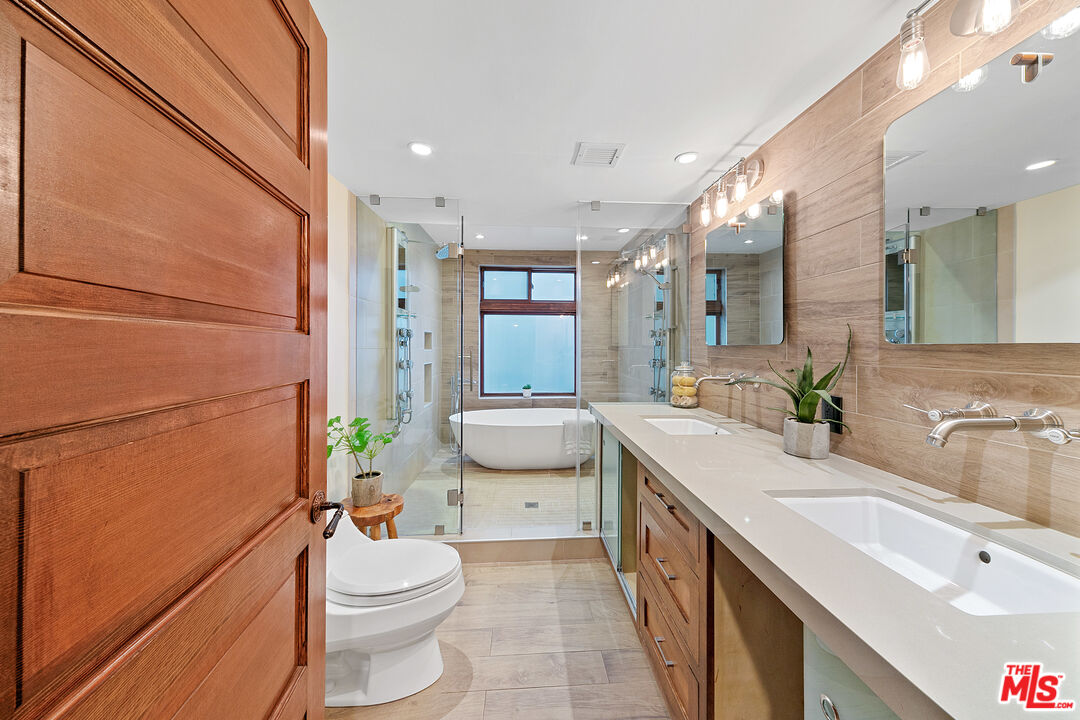 25659 Aline Way Calabasas, CA 91302 - Photo 28 of 53 a bathroom with a sink a toilet and shower