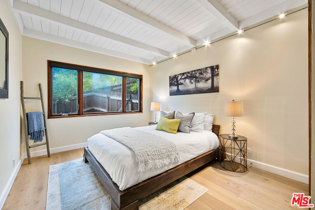 25659 Aline Way Calabasas, CA 91302 - Photo 31 of 53 a bedroom with a large bed and a large window with outer view