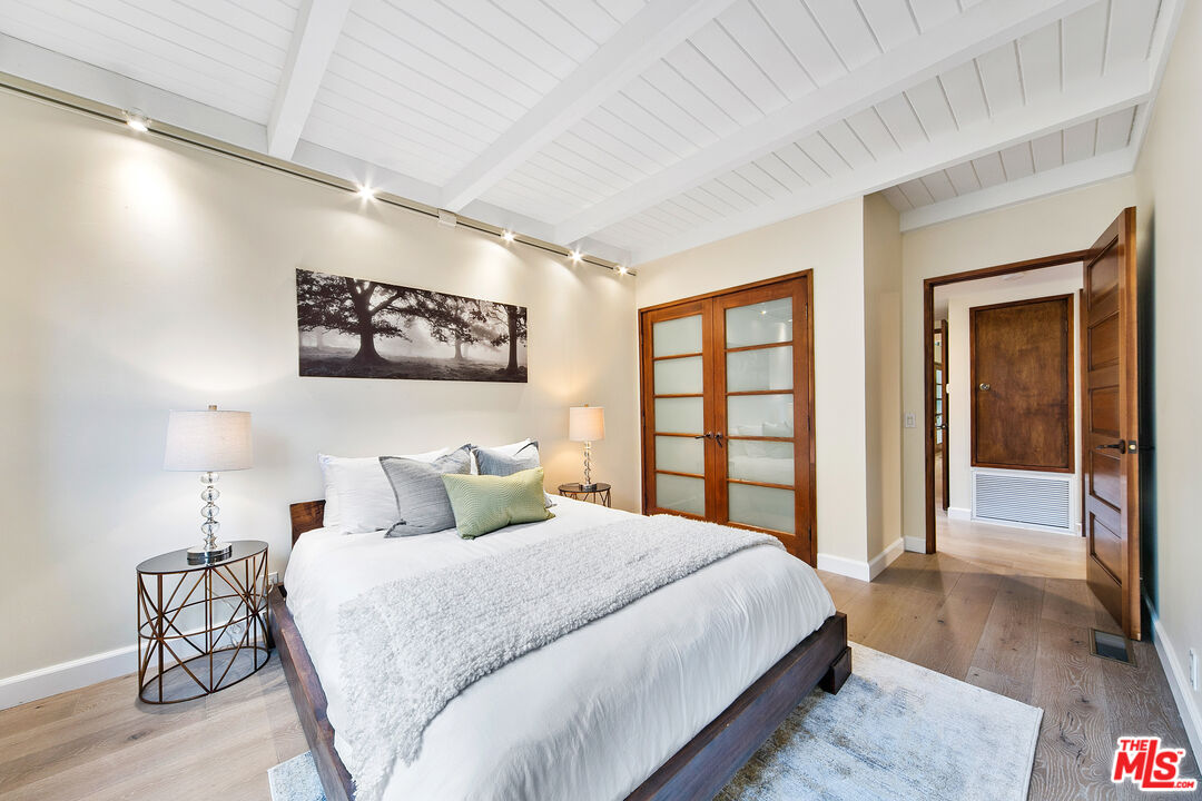 25659 Aline Way Calabasas, CA 91302 - Photo 32 of 53 a bedroom with a large bed and a large window