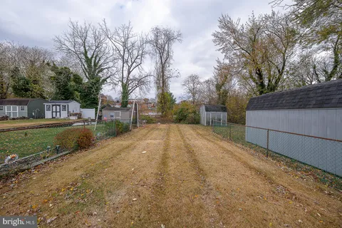 a view of a yard with wooden fence