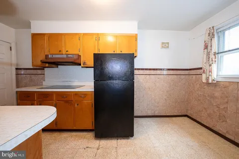 a refrigerator freezer sitting in a kitchen with stainless steel appliances granite countertop cabinets and a refrigerator