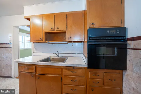 a kitchen with sink cabinets and microwave