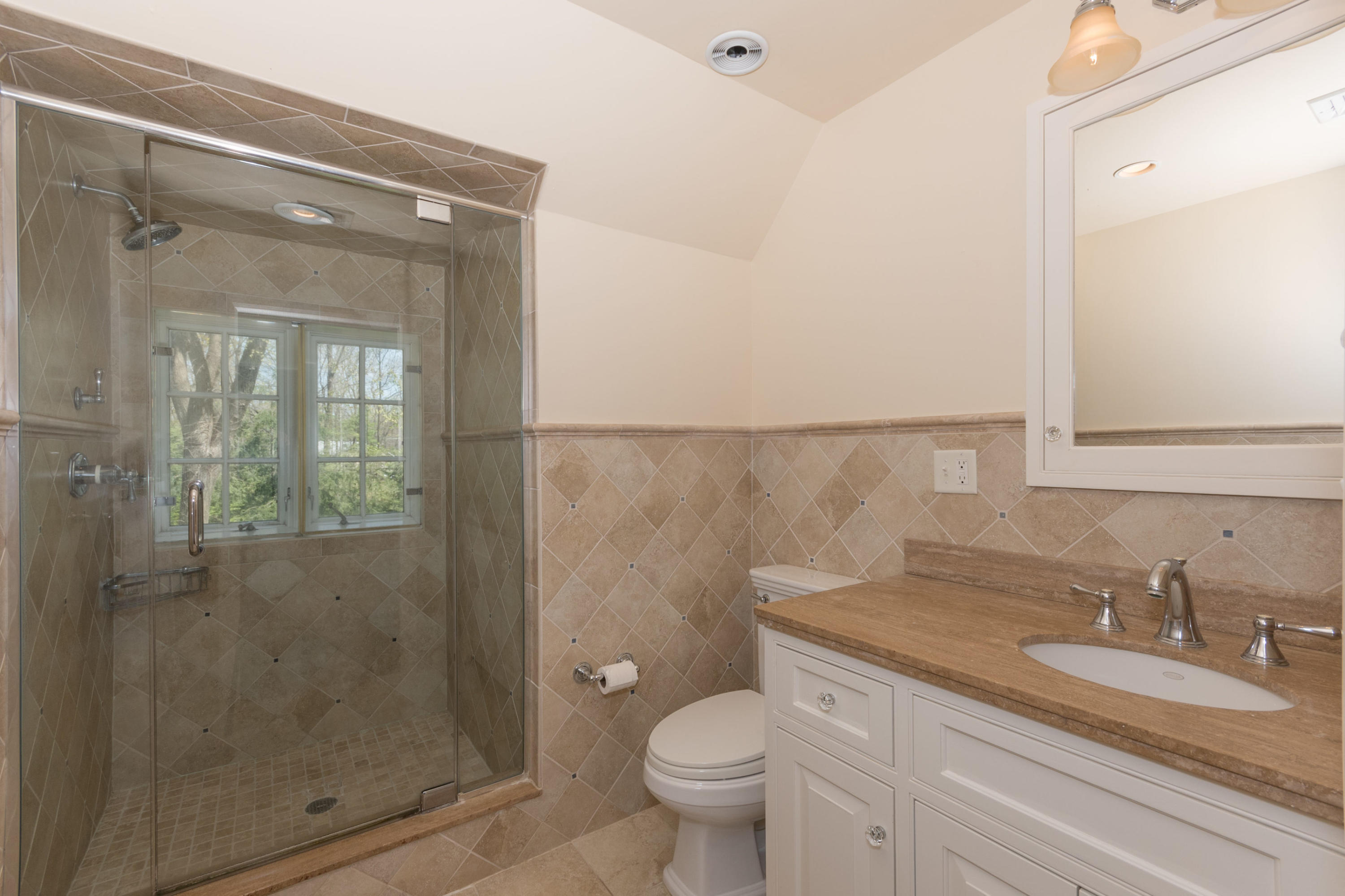 170 Ridge Acres Road Darien, CT 06820 - Photo 28 of 50 a bathroom with a granite countertop sink a toilet and shower